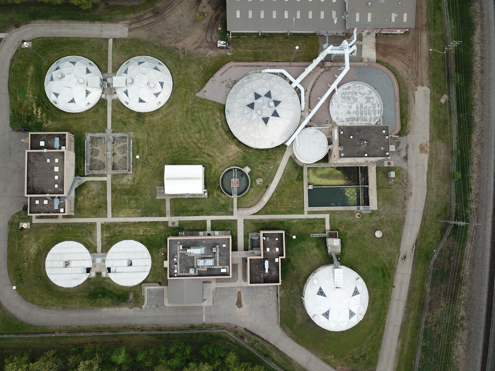 Aerial view of water treatment tanks and service infrastructure.